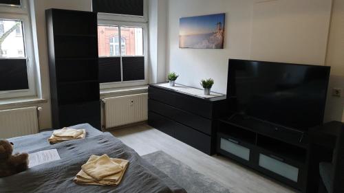 a living room with a large flat screen tv at Goethe 2 - Mitten im Zentrum von Schwerin in Schwerin