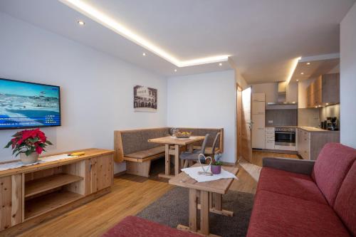a living room with a couch and a table at Postgasthof Fischerwirt in Walchsee