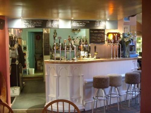 a bar with bar stools in a room at The Wookey Hole Inn in Wells