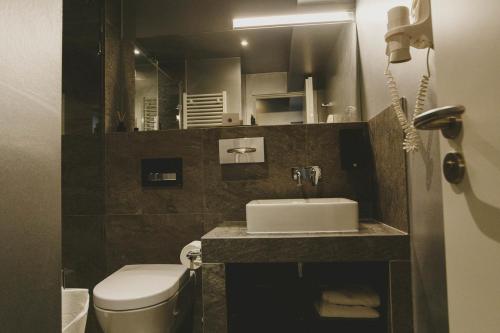 a small bathroom with a sink and a toilet at JJ32 in Luxembourg