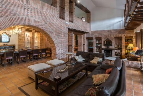 a living room filled with furniture and a brick wall at Molino De La Vega in Arcos