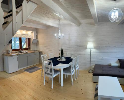 a kitchen and dining room with a table and chairs at Domek na górce in Duszniki Zdrój