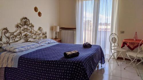 a bedroom with a bed with a blue comforter at Peppino's Room in Naples