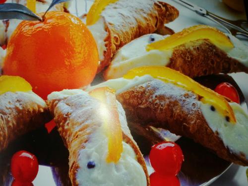 a plate of food with oranges and fruit on it at Alessi Suites & Studio in Mazzarino