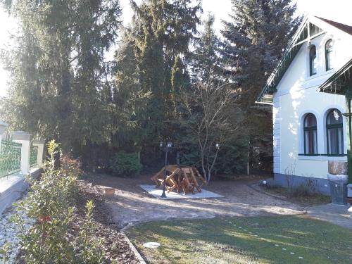 a wooden cow in a yard next to a house at Szalay Villa in Veszprém