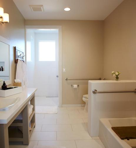 a bathroom with a tub and a toilet and a sink at SummerWood Inn in Paso Robles