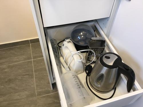 a cupboard filled with dishes and utensils at Nordanå Gård in Strö