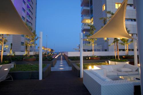a walkway with couches and tables in a building at Olympic Residence Deluxe Apartments in Limassol