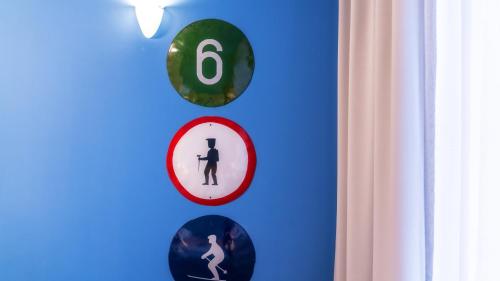 a blue wall with four clocks on it at Gronie Ski & Bike in Szczyrk