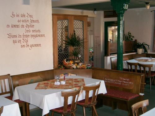 a dining room with a table and chairs and a table and chairsktop at Hotel Gaum in Biberach-Ummendorf