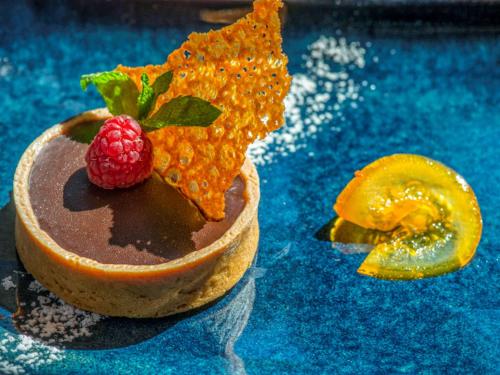 a chocolate dessert with a raspberry on top of it at Novotel Marseille Centre Prado Vélodrome in Marseille