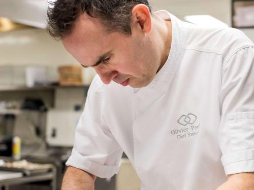a man in a kitchen wearing a white shirt at Sofitel Montreal Golden Mile in Montréal