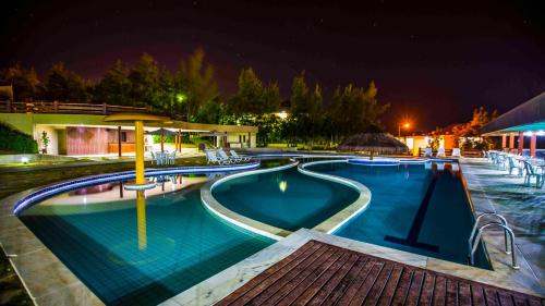 a large swimming pool at night at Hotel Fazenda Monte Castelo in Gravatá