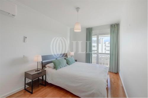 a white bedroom with a bed and a window at Boutique Apartment - 2 Bedroom - Lisbon City Center in Lisbon