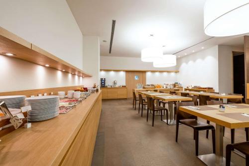a dining room with wooden tables and chairs at HSM Hotel San Martino in Garbagnate Monastero 