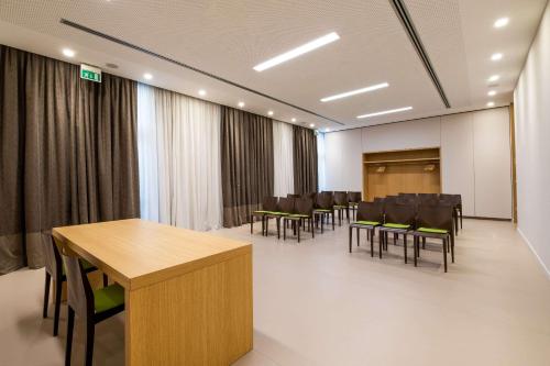 a conference room with chairs and a table and a podium at HSM Hotel San Martino in Garbagnate Monastero 