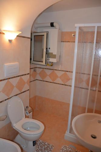 a bathroom with a toilet and a sink at Antica Casa Cavaliere in Tramonti