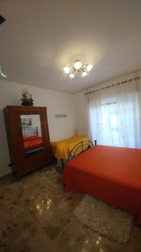 a bedroom with a red bed and a mirror at B&B Palazzo Armini in Rogliano