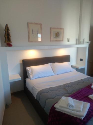a bedroom with a large bed with two white pillows at B & B MARIMA ORGOSOLO in Orgosolo