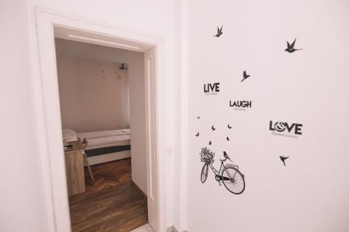 a room with a bike stenciled on the wall at De lux Apartment & Rooms Emilia in Banja Luka