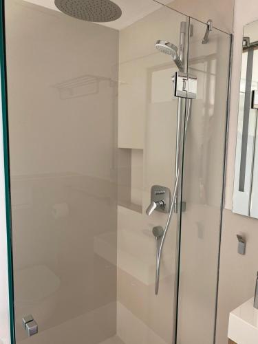 a shower with a glass door in a bathroom at Haus Ingrid in Kitzbühel
