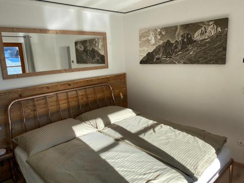 a bedroom with a bed and a mirror on the wall at Haus Ingrid in Kitzbühel