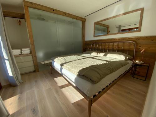 a bedroom with a bed with a mirror on the wall at Haus Ingrid in Kitzbühel