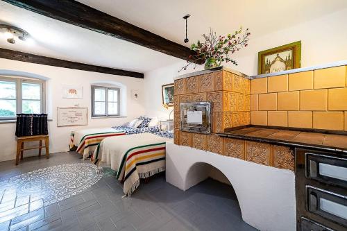 a large bedroom with two beds and a fireplace at Rusty's Cottage in Sedlčany