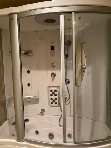 a shower in a bathroom with a glass wall at Bollywood Beach Hostel in Dubai