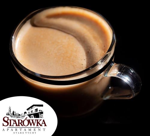 a close up of a cup of coffee at STARÓWKA Apartament Stare Tychy in Tychy