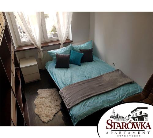 a small bed in a room with a window at STARÓWKA Apartament Stare Tychy in Tychy