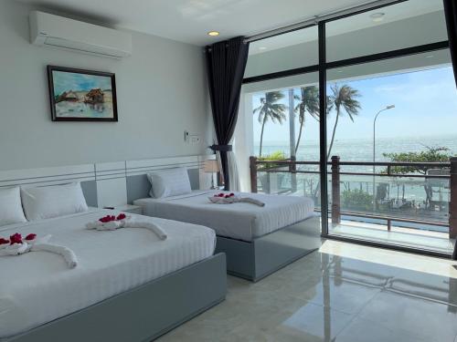 Postel nebo postele na pokoji v ubytování Vivian Hotel Mui Ne