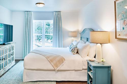 een slaapkamer met een groot bed en een raam bij Hotel Simone in Saint Simons Island