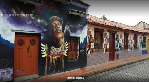a mural of a woman on the side of a building at El Yarumo Hostel in Bogotá