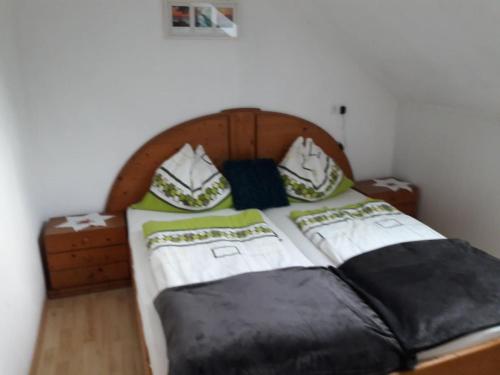 a bed with black and white sheets and pillows at Ferienwohnung Brandstatter in Windischgarsten