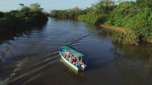 a group of people in a boat on a river at Natural Lodge Caño Negro in Caño Negro