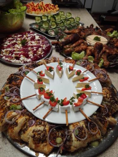 a table with many plates of food on it at Wellness penzion Harmonie Rohanov in Prachatice