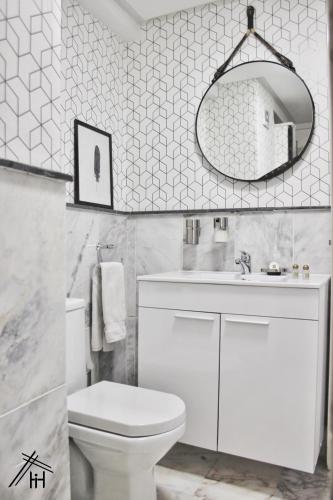 a bathroom with a toilet and a sink and a mirror at AiM HOUSE in Marrakech
