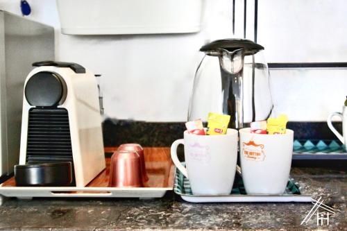 two coffee cups sitting on a kitchen counter at AiM HOUSE in Marrakech