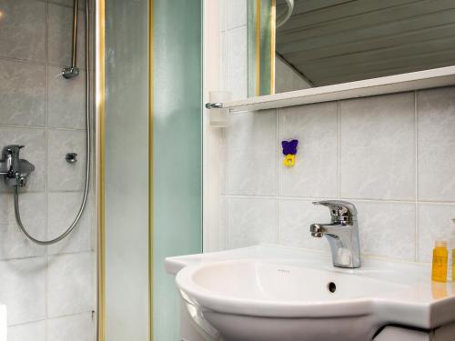 a bathroom with a sink and a shower at Apartments Grifone Lux in Herceg-Novi