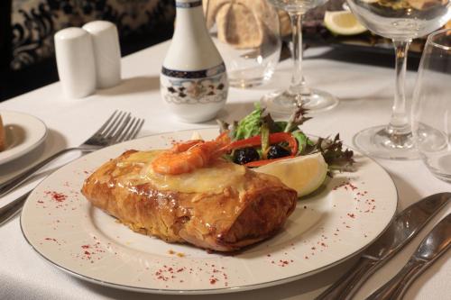 a white plate with a piece of food on a table at Le Palace d'Anfa in Casablanca