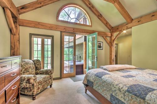 a bedroom with a bed and a chair and a window at Rivers Edge Mtn Home Private Hot Tub and Views in Glenwood Springs