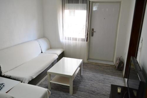 a living room with a white couch and a table at Apartment in Prilep in Prilep