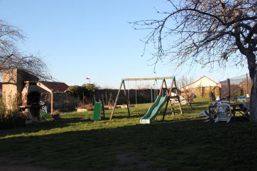 a playground with a swing set in a yard at Château Besson in Montluçon