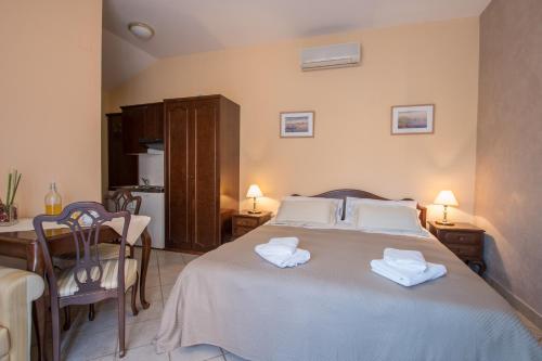 a bedroom with a bed with two towels on it at Apartments Viler in Buje