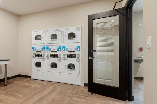 a laundry room with four washer and dryer machines at Extended Stay America Premier Suites - Tampa - Gibsonton - Riverview in Gibsonton