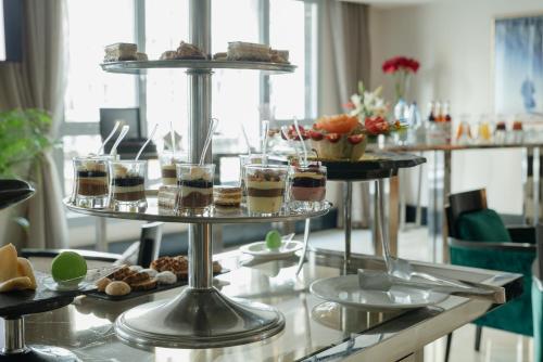 a table with three tiers of pastries on a buffet at Le Palace d'Anfa in Casablanca