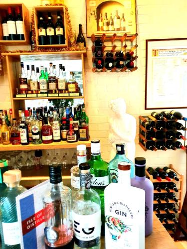 a bunch of bottles of alcohol sitting on a counter at Lubnaig Guest House in Callander