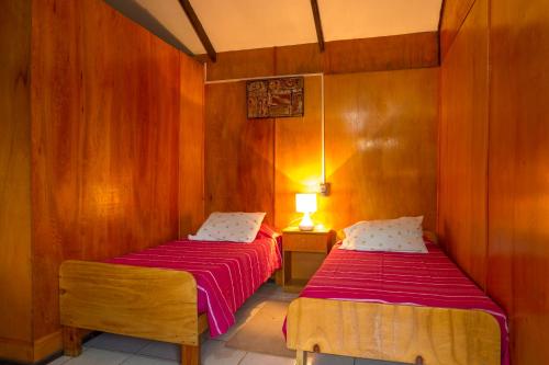 Кровать или кровати в номере Cabañas Nua e Koro