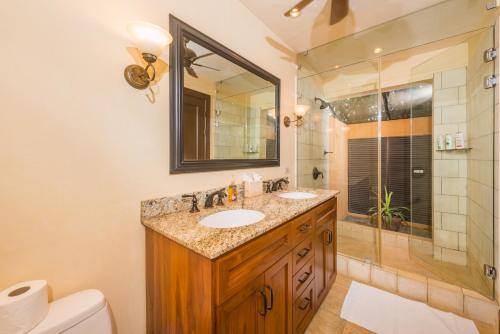 a bathroom with two sinks and a shower at Jet Luxury at Langosta Beach Resort & Villas in Tamarindo